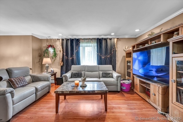 77 Oxbow Lane West Haven, CT 06516 - Photo 16 of 27 a living room with furniture and a flat screen tv