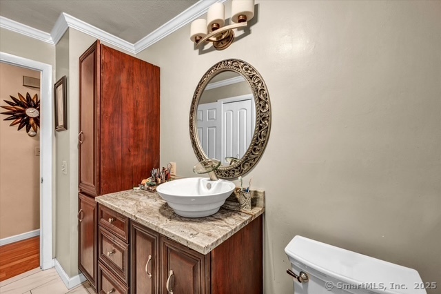 77 Oxbow Lane West Haven, CT 06516 - Photo 18 of 27 a bathroom with a granite countertop sink a toilet mirror and vanity
