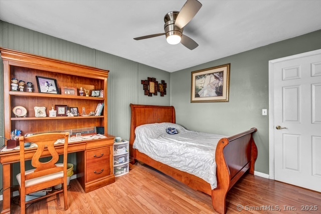 77 Oxbow Lane West Haven, CT 06516 - Photo 19 of 27 a bedroom with furniture and a book shelf