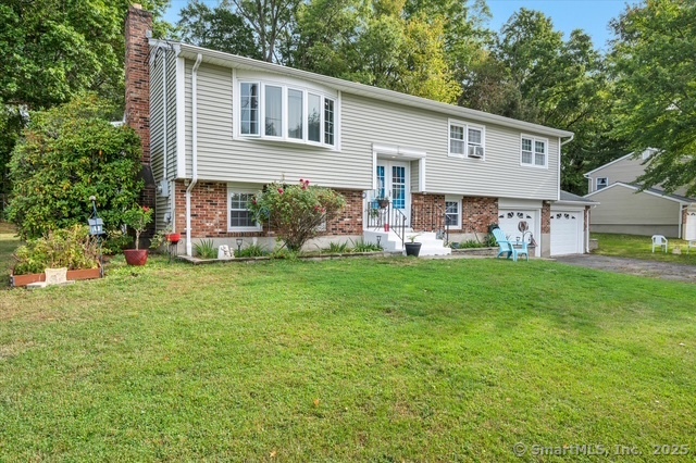 77 Oxbow Lane West Haven, CT 06516 - Photo 2 of 27 a front view of house with yard and green space