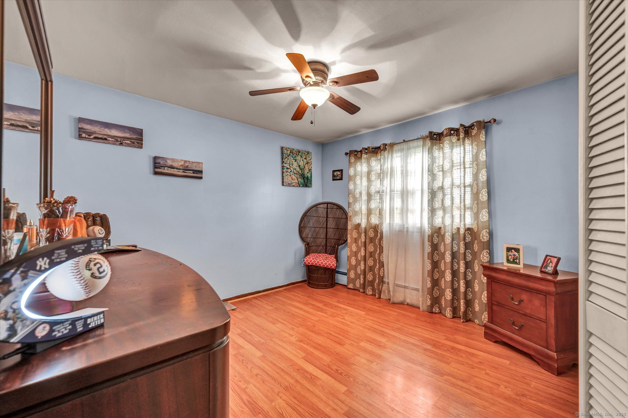 77 Oxbow Lane West Haven, CT 06516 - Photo 22 of 27 a bedroom with a bed and wooden floor