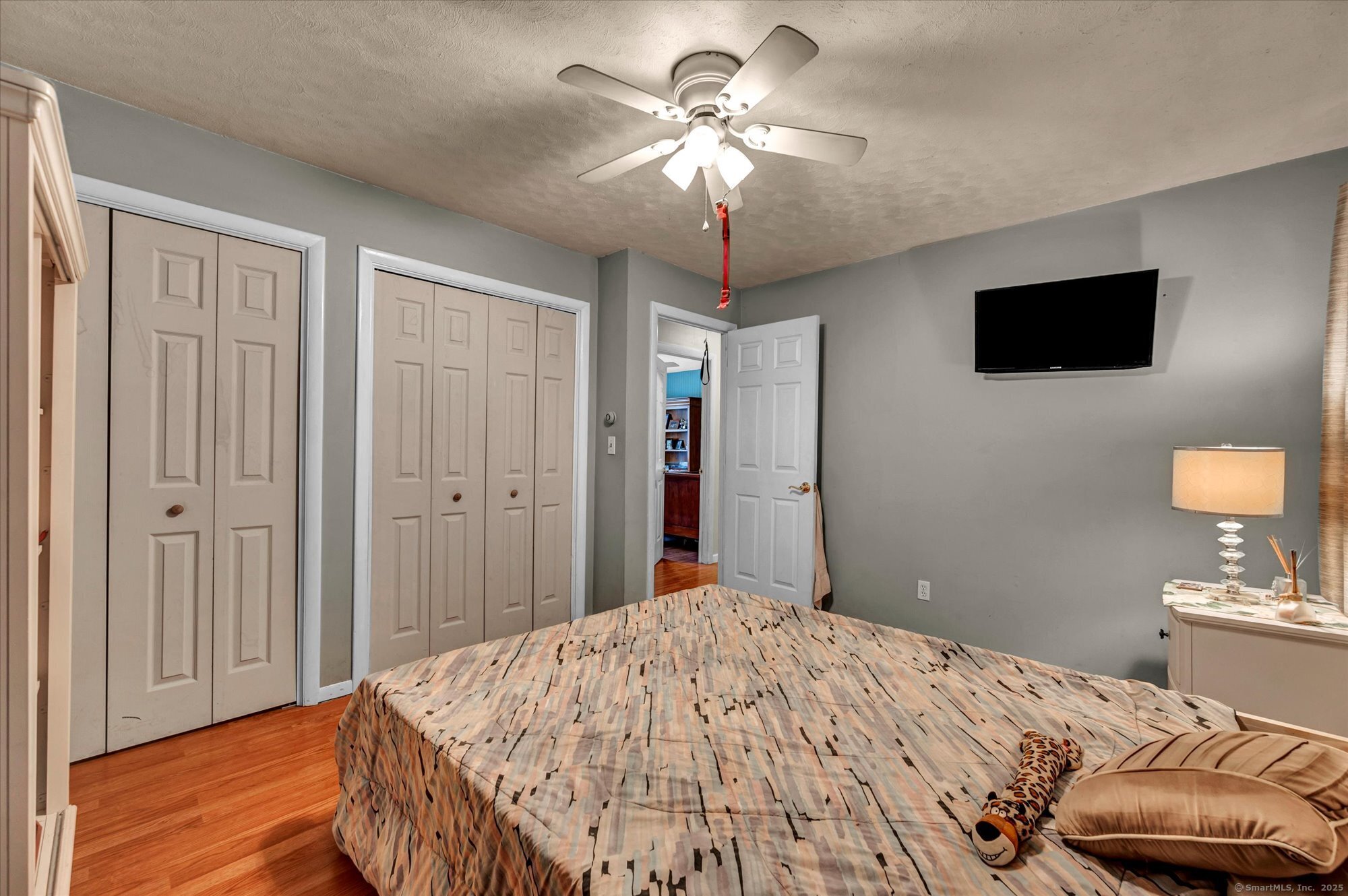 77 Oxbow Lane West Haven, CT 06516 - Photo 23 of 27 a bedroom with a bed and a chandelier