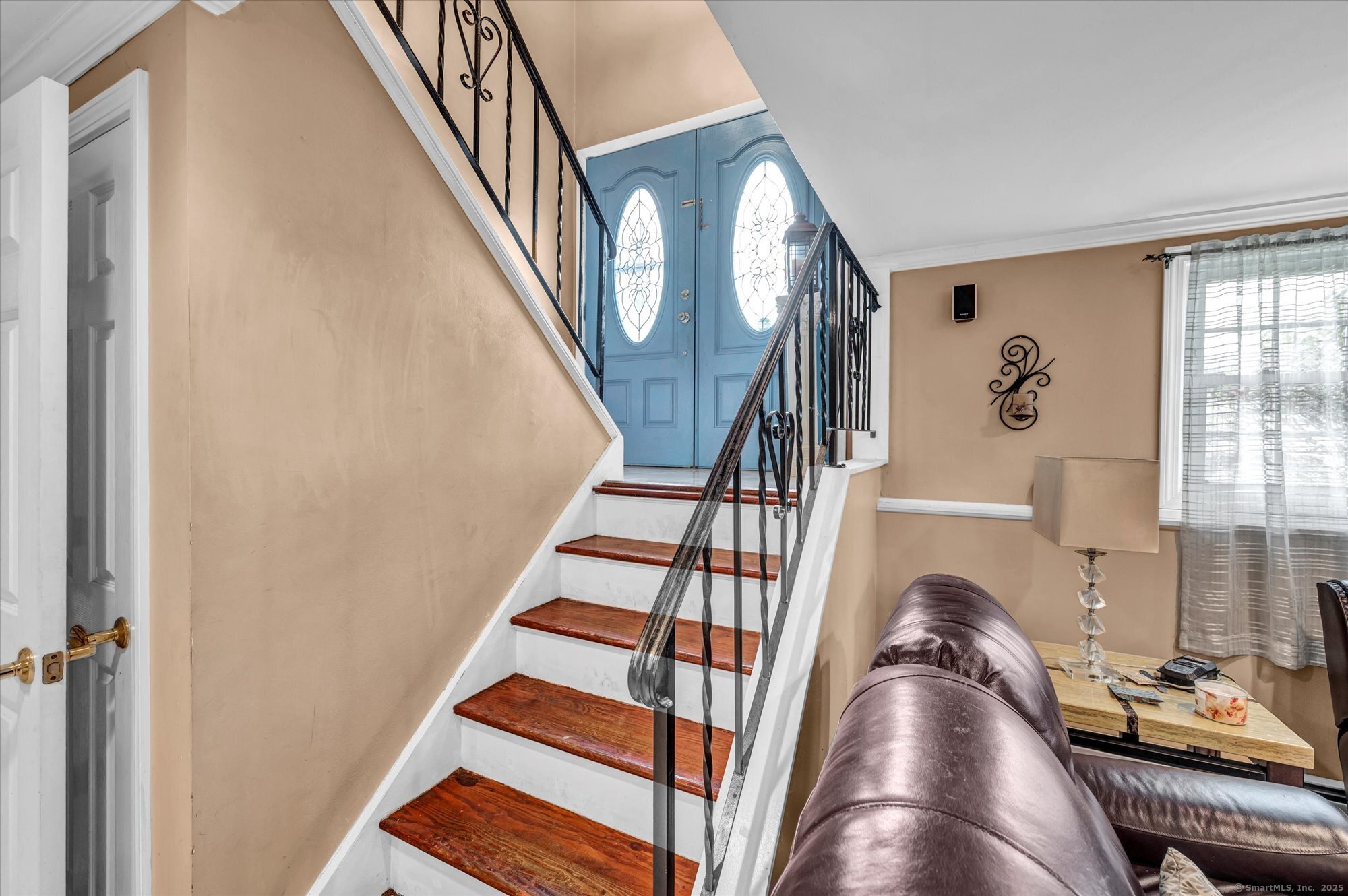 77 Oxbow Lane West Haven, CT 06516 - Photo 24 of 27 a view of staircase with lots of frames on wall and a window