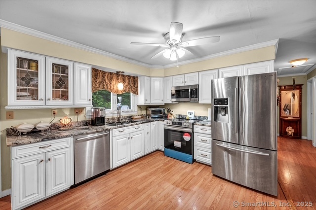 77 Oxbow Lane West Haven, CT 06516 - Photo 8 of 27 a kitchen with stainless steel appliances a sink cabinets a refrigerator and a stove top oven