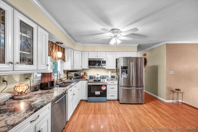 77 Oxbow Lane West Haven, CT 06516 - Photo 9 of 27 a kitchen with stainless steel appliances granite countertop a refrigerator a stove top oven a sink and dishwasher