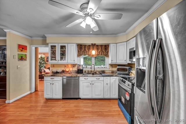 77 Oxbow Lane West Haven, CT 06516 - Photo 10 of 27 a kitchen with stainless steel appliances granite countertop a stove top oven a refrigerator a sink and dishwasher with wooden floor