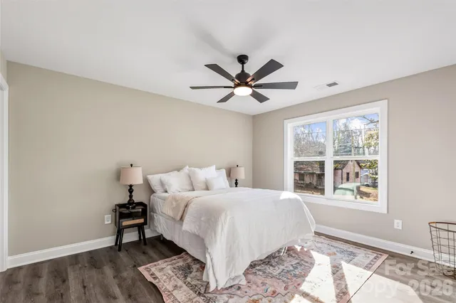 a bedroom with a large bed and a window