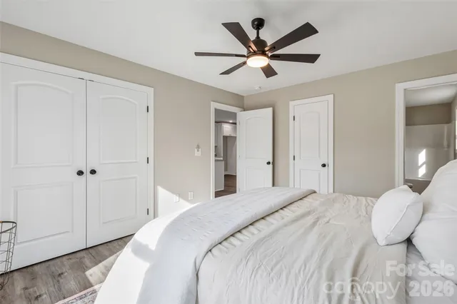 a bedroom with a large bed and a chandelier