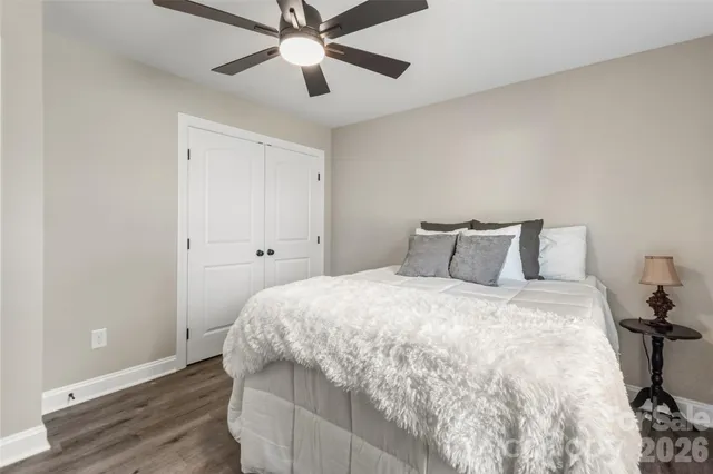 a bedroom with a bed and a ceiling fan