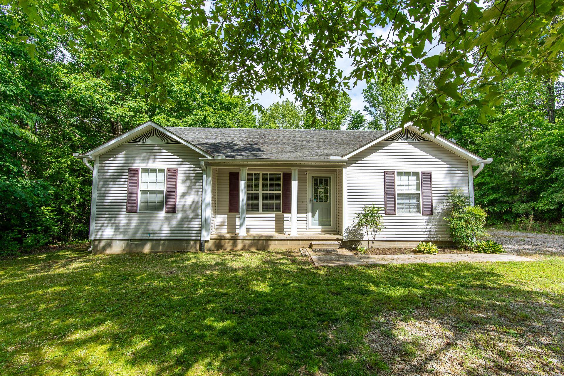 a front view of house with yard and green space