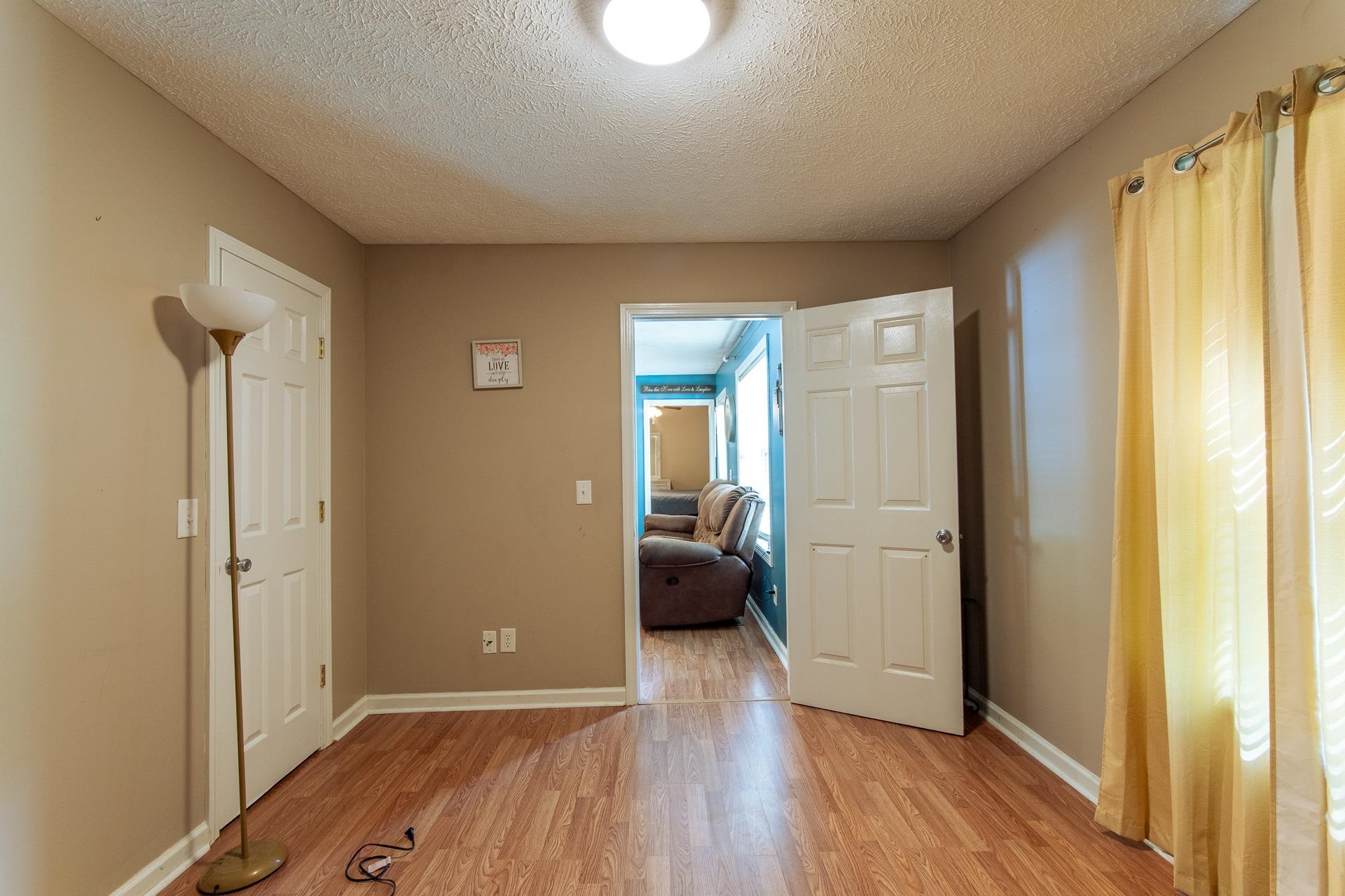 5584 Ramer Selmer Road Selmer, TN 38375 - Photo 12 of 31 a view of a room with wooden floor and windows