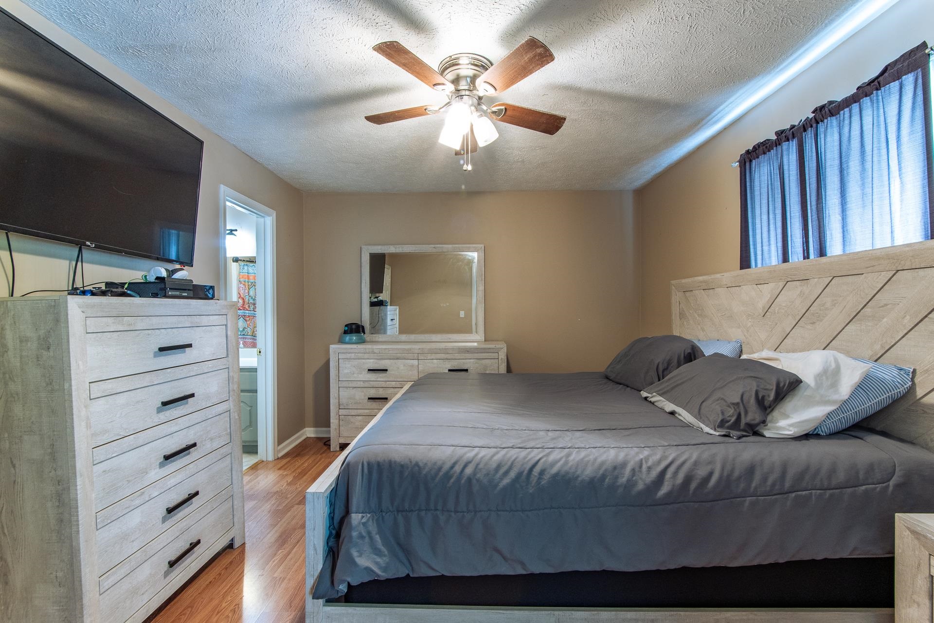 5584 Ramer Selmer Road Selmer, TN 38375 - Photo 13 of 31 a bedroom with a large bed and a flat screen tv
