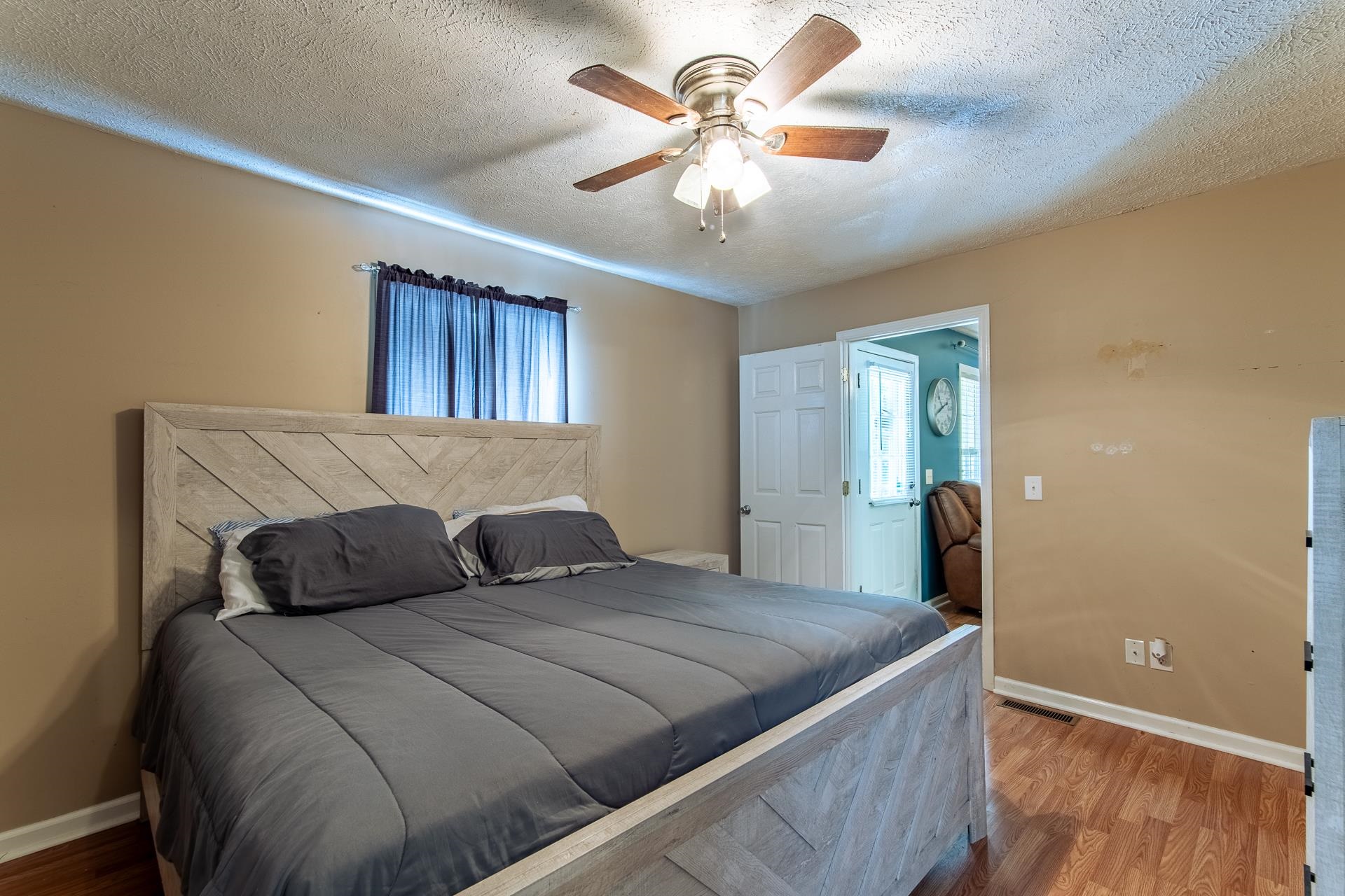 5584 Ramer Selmer Road Selmer, TN 38375 - Photo 19 of 31 a bedroom with a large bed and a chandelier