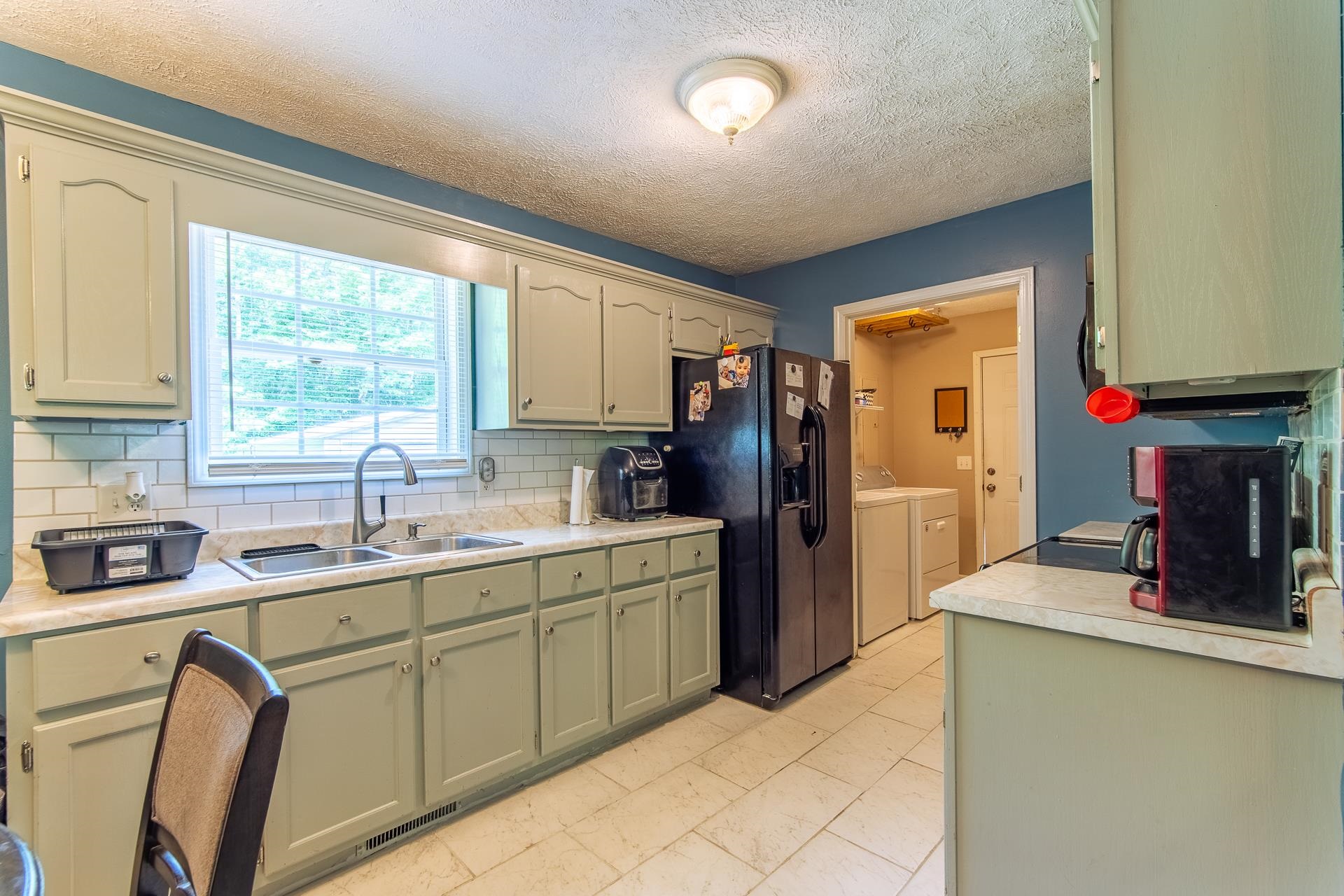 5584 Ramer Selmer Road Selmer, TN 38375 - Photo 24 of 31 a kitchen with a sink appliances cabinets and a window