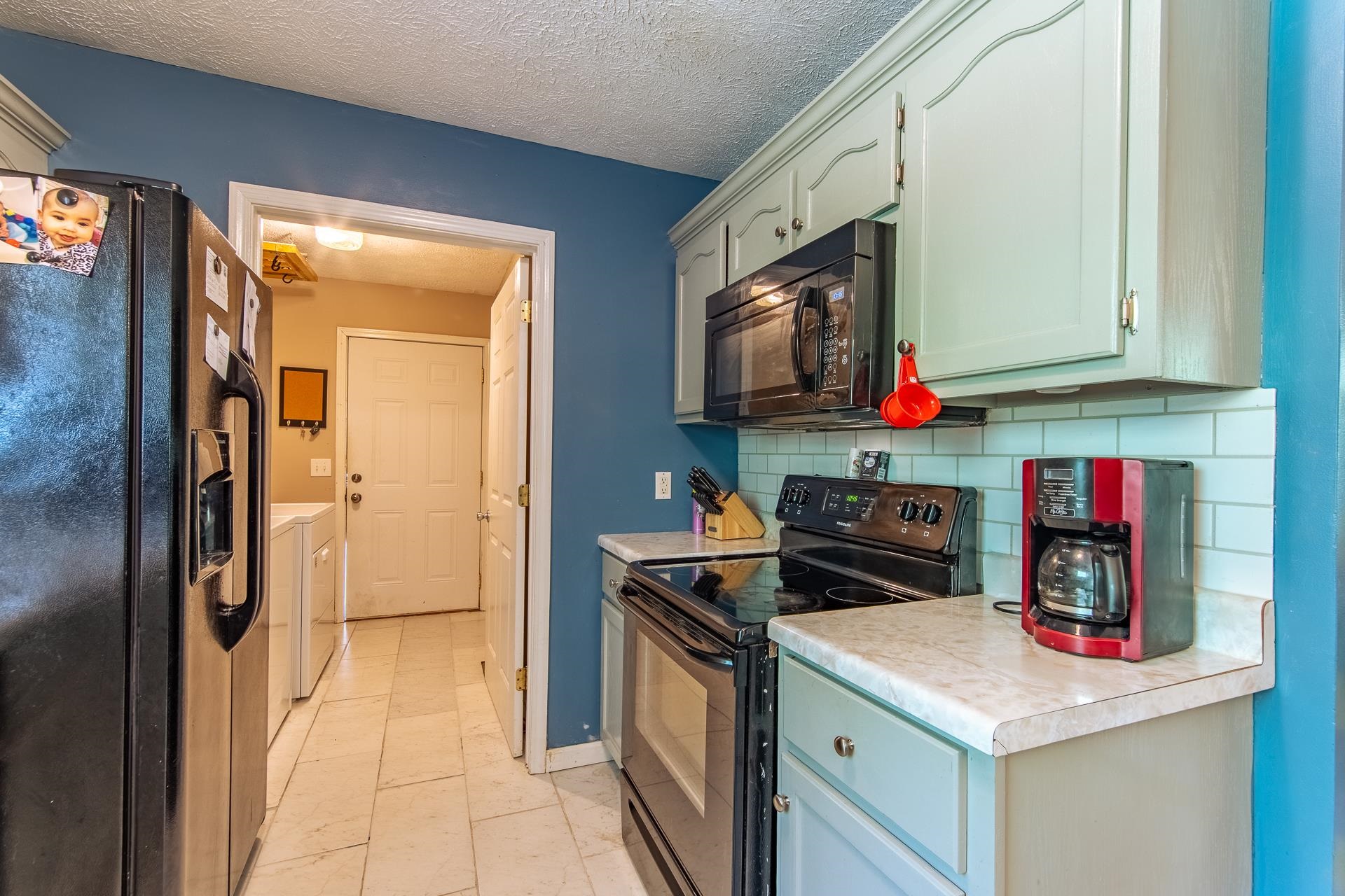 5584 Ramer Selmer Road Selmer, TN 38375 - Photo 26 of 31 a kitchen with stainless steel appliances granite countertop a stove and a refrigerator