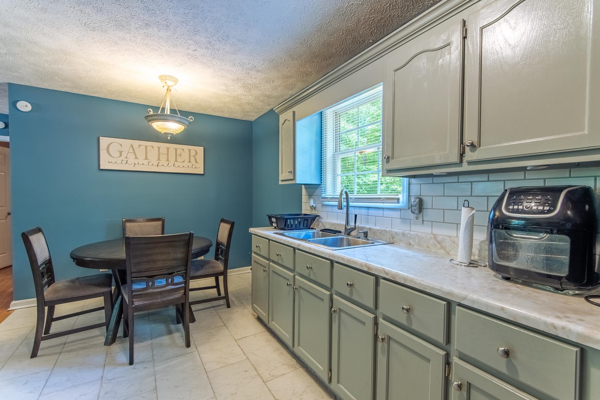 5584 Ramer Selmer Road Selmer, TN 38375 - Photo 29 of 31 a kitchen with a chair and cabinets