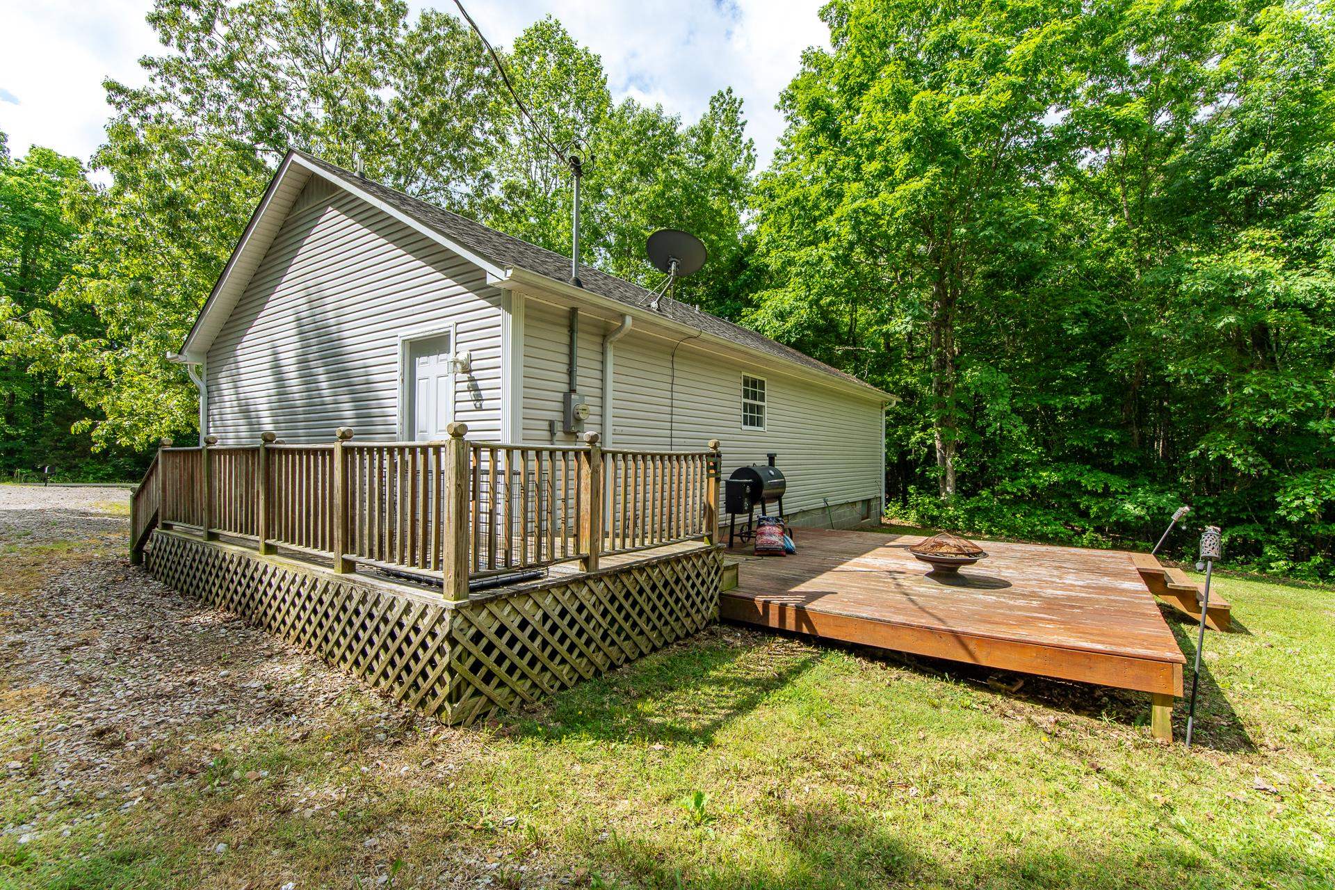 5584 Ramer Selmer Road Selmer, TN 38375 - Photo 4 of 31 a view of a house with a wooden deck and a yard
