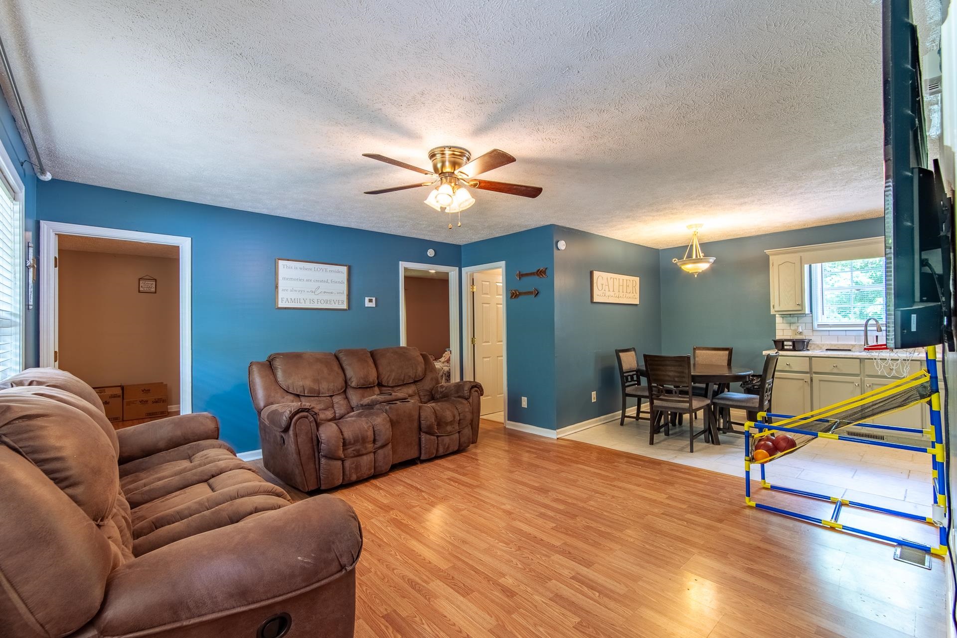 5584 Ramer Selmer Road Selmer, TN 38375 - Photo 10 of 31 a living room with furniture a desk and chair with wooden floor