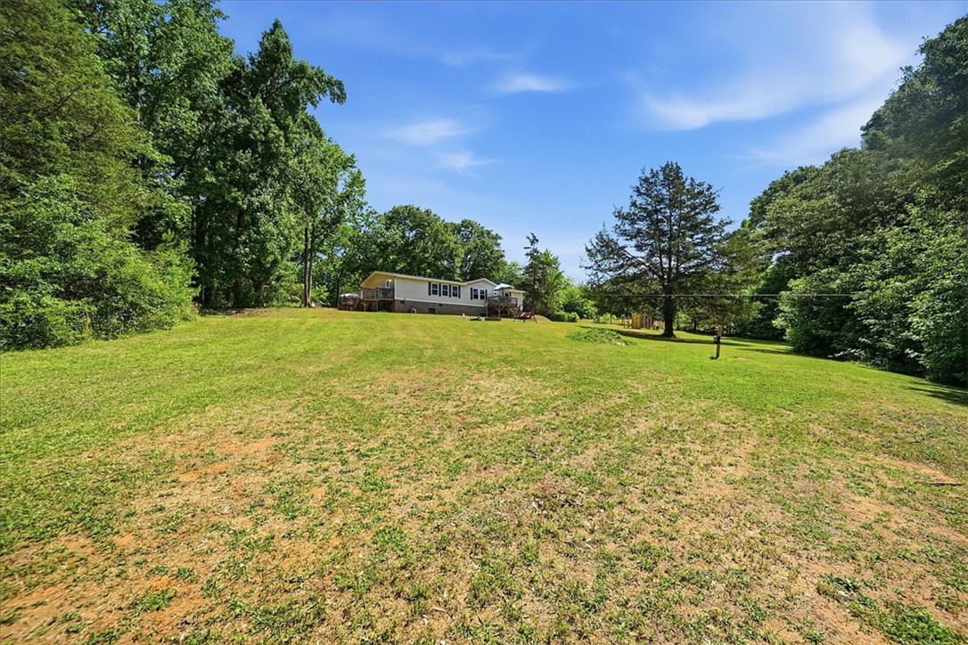 1014 Harris Road Anderson, SC 29625 - Photo 26 of 34 An inviting residence set on a verdant hillside, embraced by a lush, natural landscape.