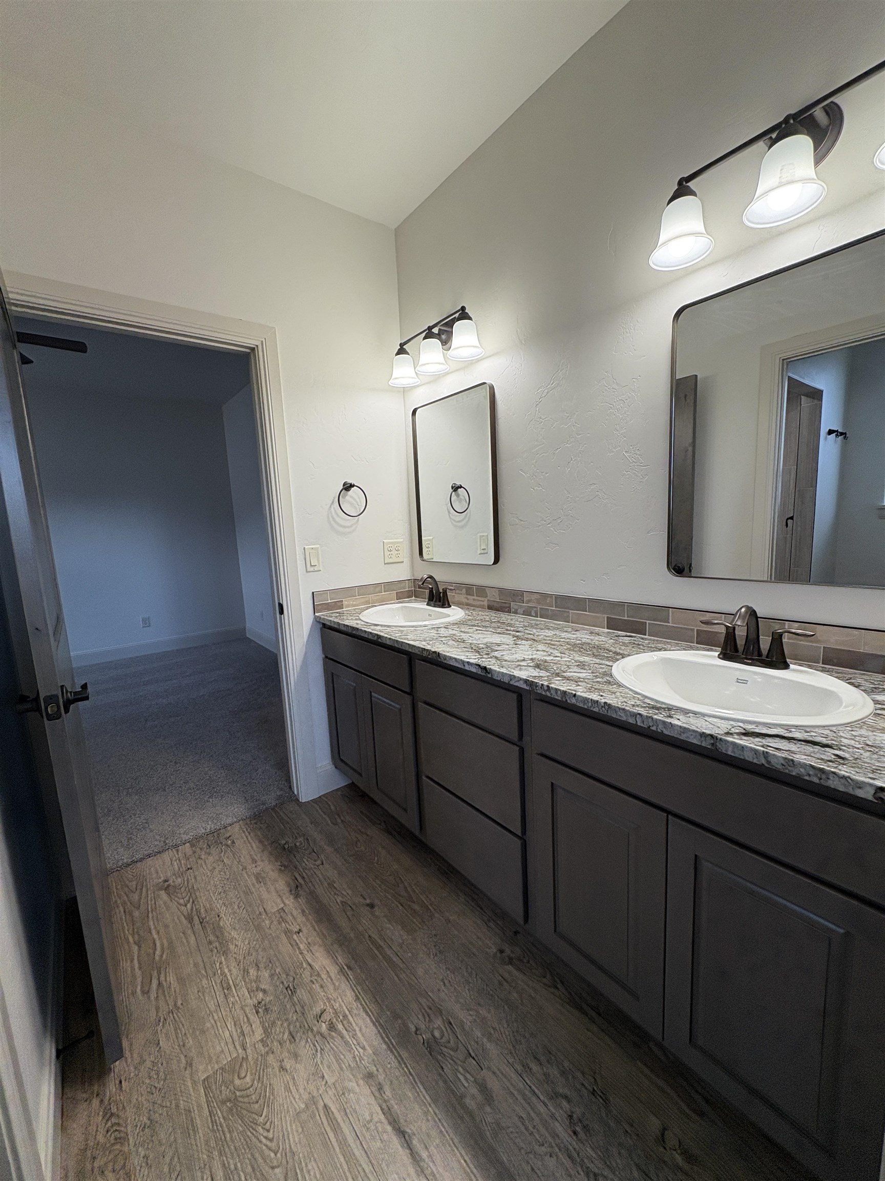 2641 Emerald Ridge Lane Grand Junction, CO 81506 - Photo 15 of 42 a spacious bathroom with a granite countertop sink and a mirror