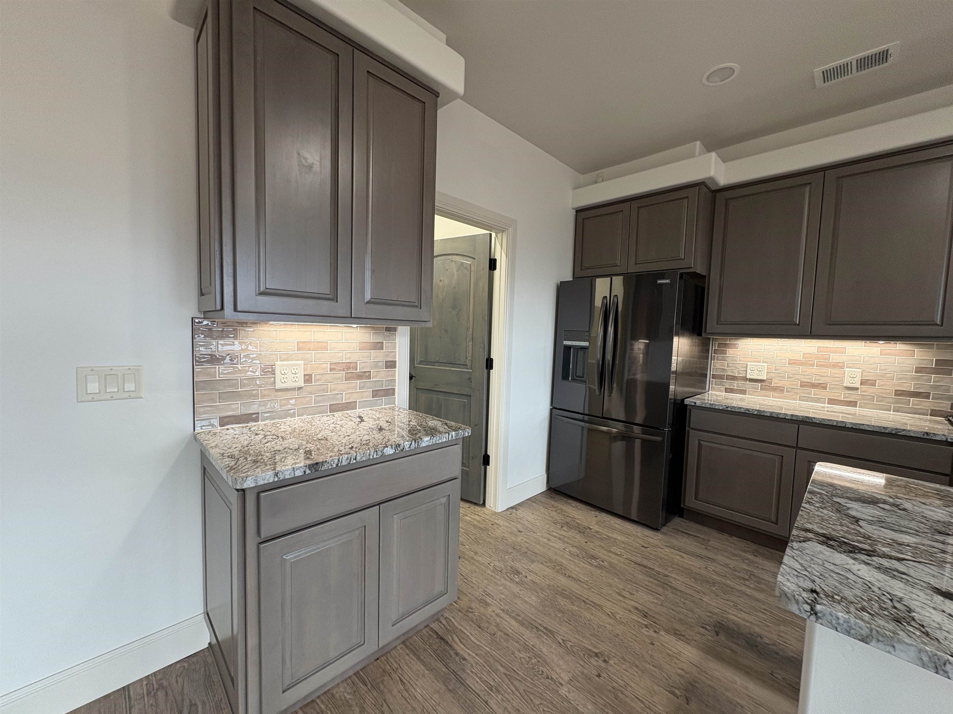 2641 Emerald Ridge Lane Grand Junction, CO 81506 - Photo 20 of 42 a kitchen with granite countertop stainless steel appliances and wooden cabinets