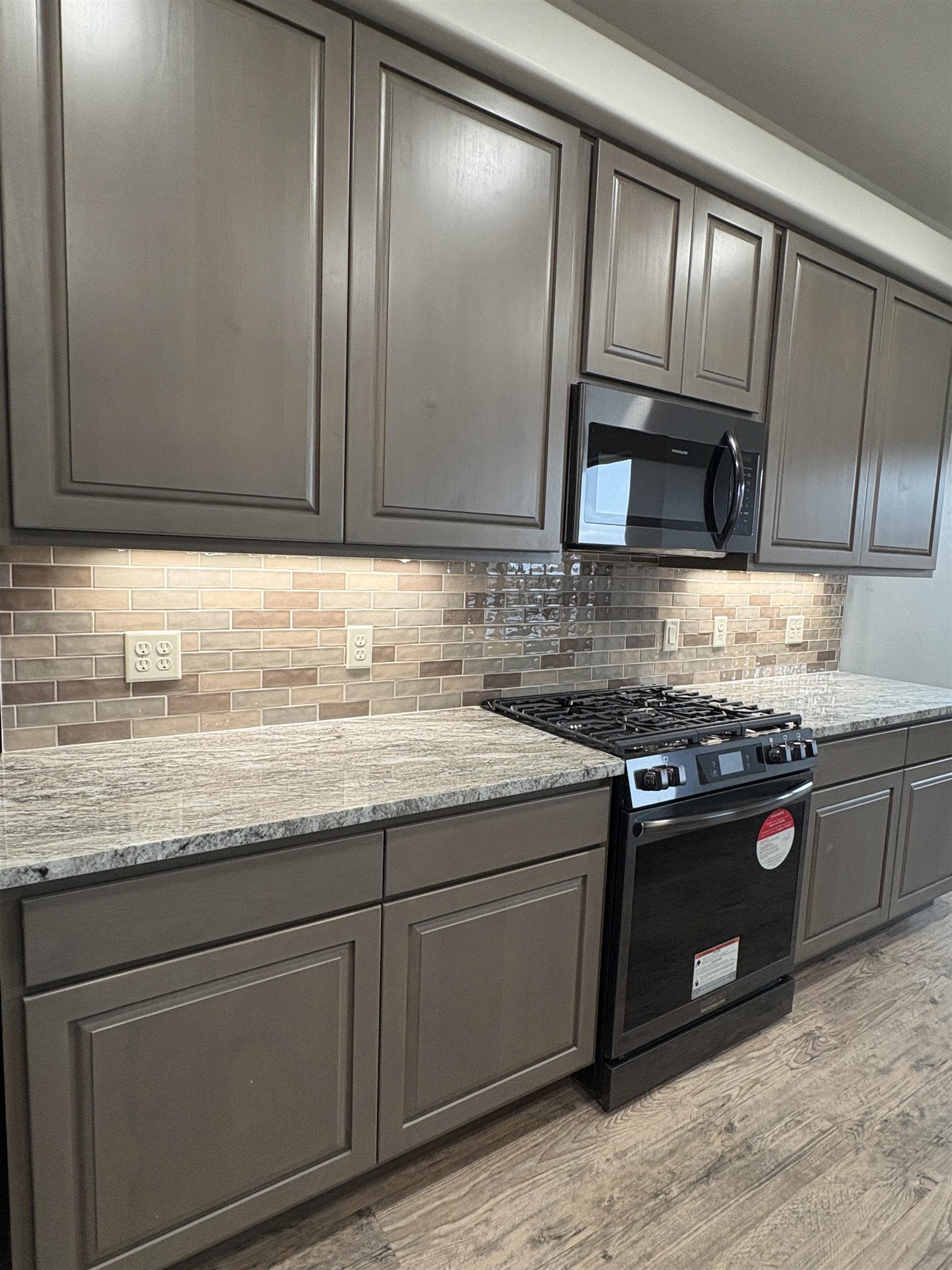 2641 Emerald Ridge Lane Grand Junction, CO 81506 - Photo 21 of 42 a kitchen with granite countertop stainless steel appliances wooden cabinets and a stove top oven