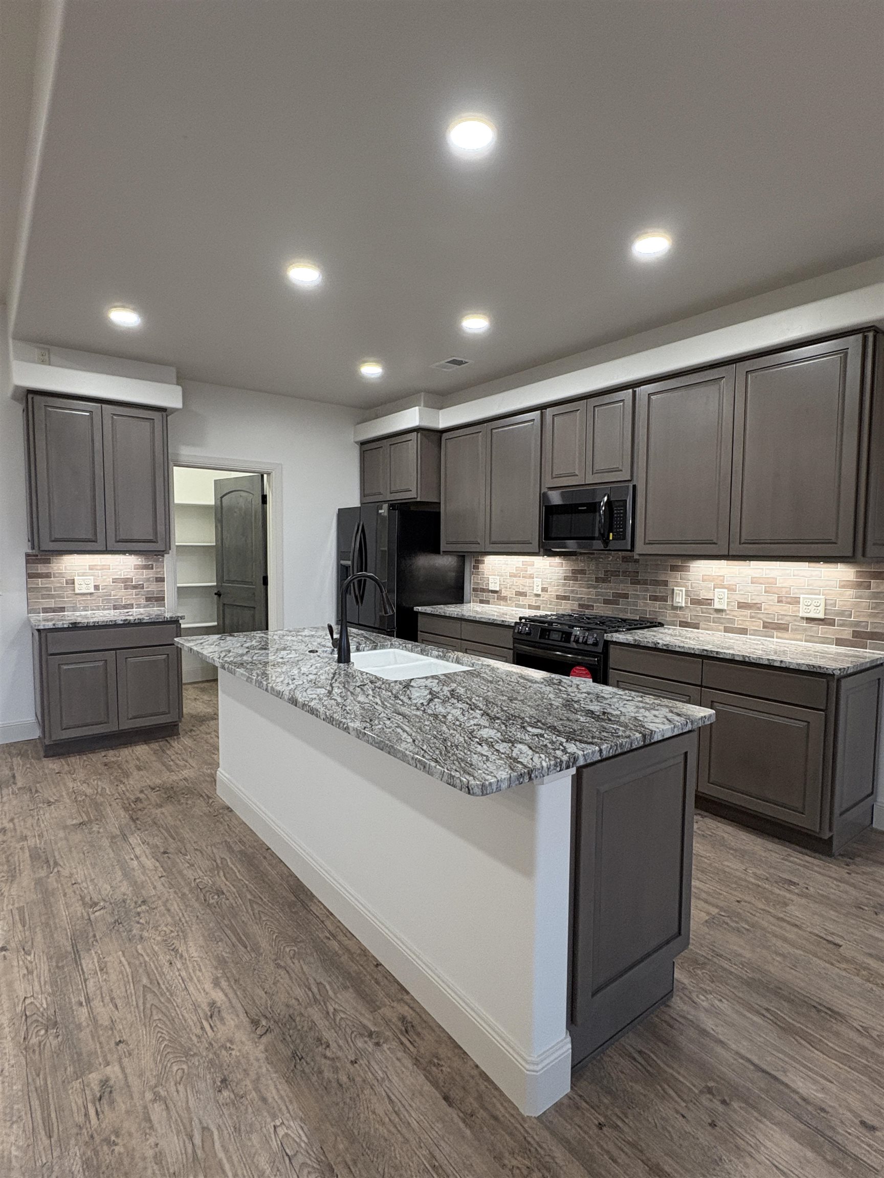 2641 Emerald Ridge Lane Grand Junction, CO 81506 - Photo 23 of 42 a kitchen with stainless steel appliances granite countertop a stove a sink a refrigerator and a oven