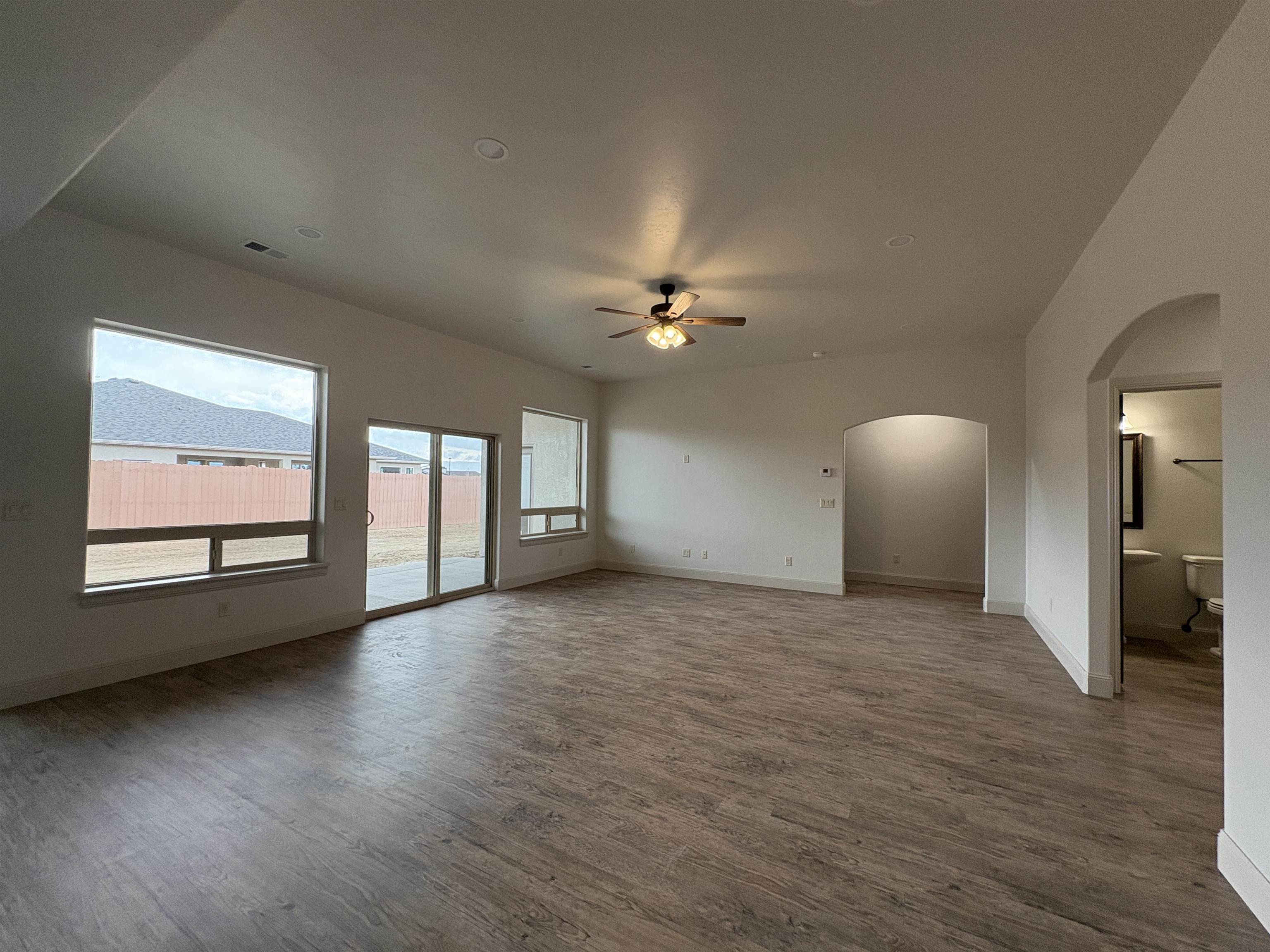 2641 Emerald Ridge Lane Grand Junction, CO 81506 - Photo 24 of 42 a view of an empty room with a window and wooden floor