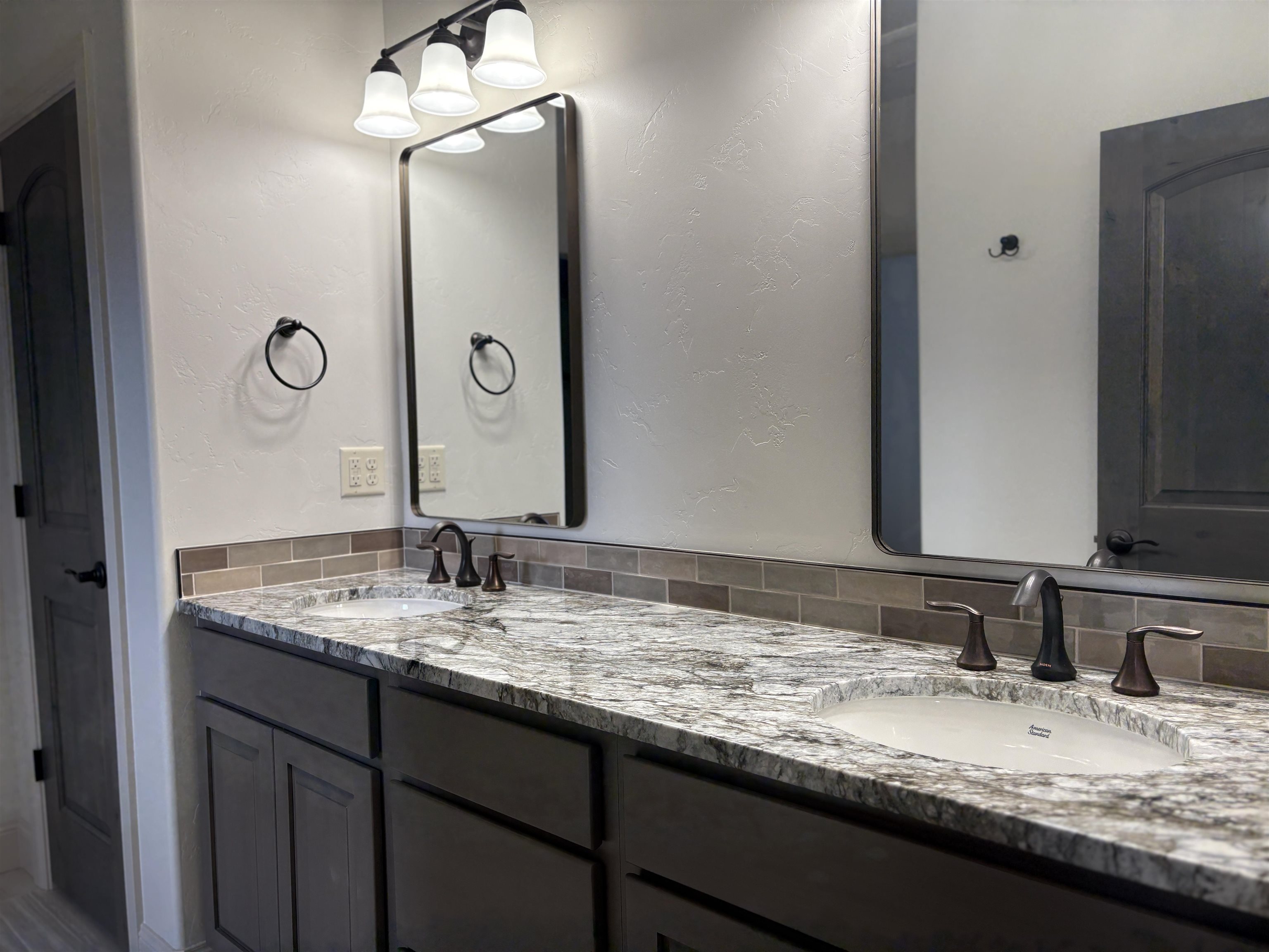 2641 Emerald Ridge Lane Grand Junction, CO 81506 - Photo 30 of 42 a bathroom with a granite countertop sink and a mirror