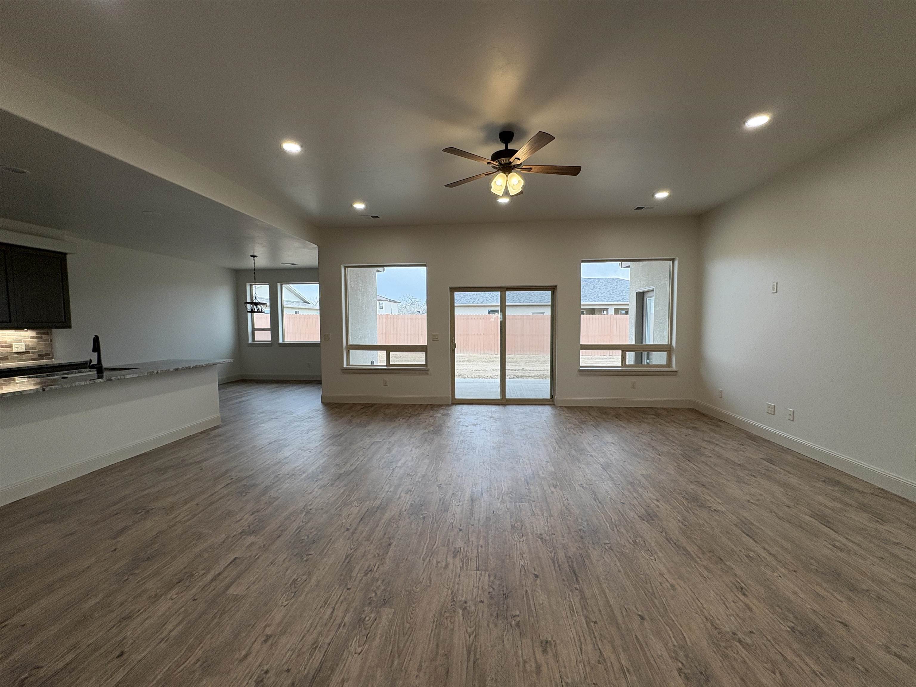 2641 Emerald Ridge Lane Grand Junction, CO 81506 - Photo 6 of 42 a view of an empty room with a window and wooden floor