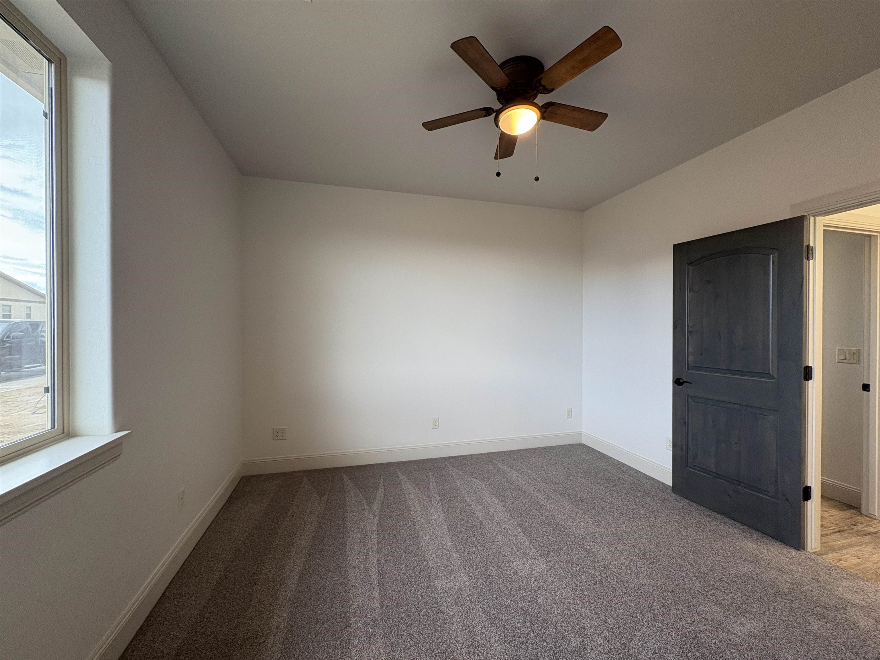 2641 Emerald Ridge Lane Grand Junction, CO 81506 - Photo 8 of 42 an empty room with a window and a ceiling fan