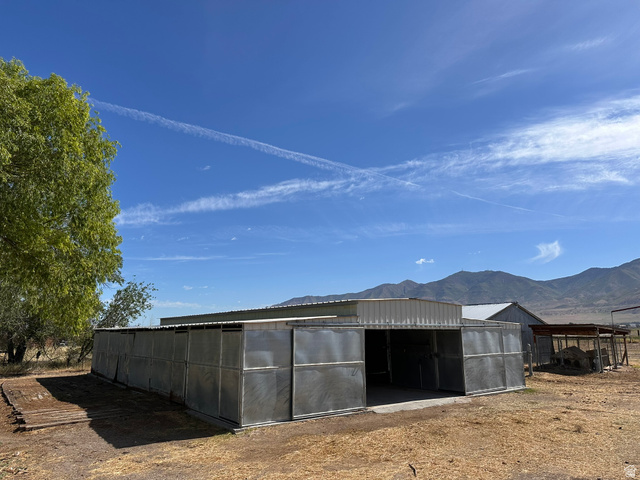 3732 Campbell Road Tooele, UT 84074 - Photo 51 of 69 Metal barn structure featuring multiple stalls and a central open bay