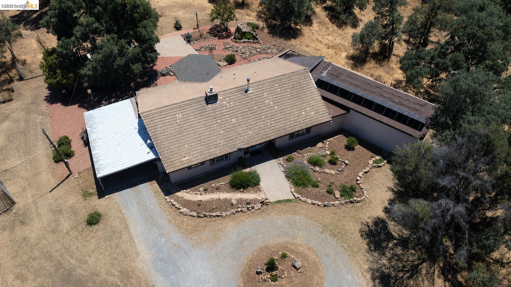 18195 Wards Ferry Road Sonora, CA 95370 - Photo 3 of 67 Single-story residence featuring a tile roof, an attached carport, and a paved driveway