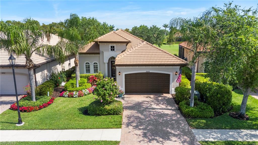 7806 Ashton Road Naples, FL 34113 - Photo 1 of 27 Mediterranean / spanish home featuring a tiled roof, decorative driveway, a garage, and stucco siding