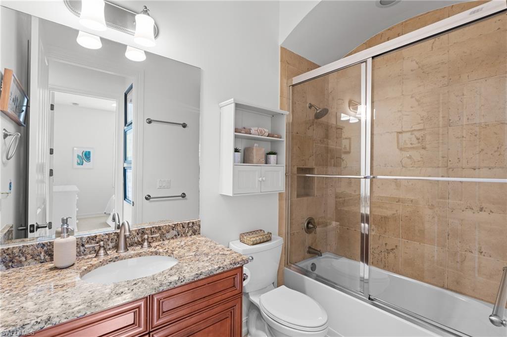 7806 Ashton Road Naples, FL 34113 - Photo 19 of 27 Bathroom with enclosed tub / shower combo, toilet, and vanity