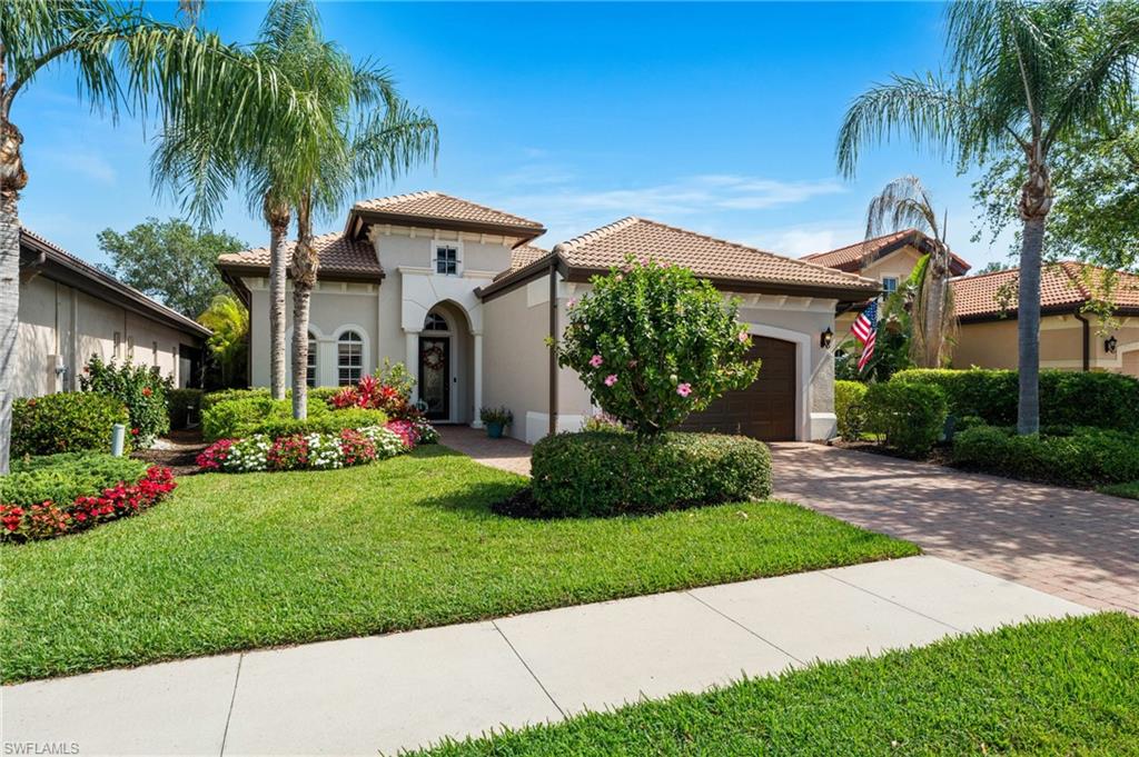 7806 Ashton Road Naples, FL 34113 - Photo 2 of 27 Mediterranean / spanish-style home with stucco siding, a tile roof, an attached garage, and decorative driveway
