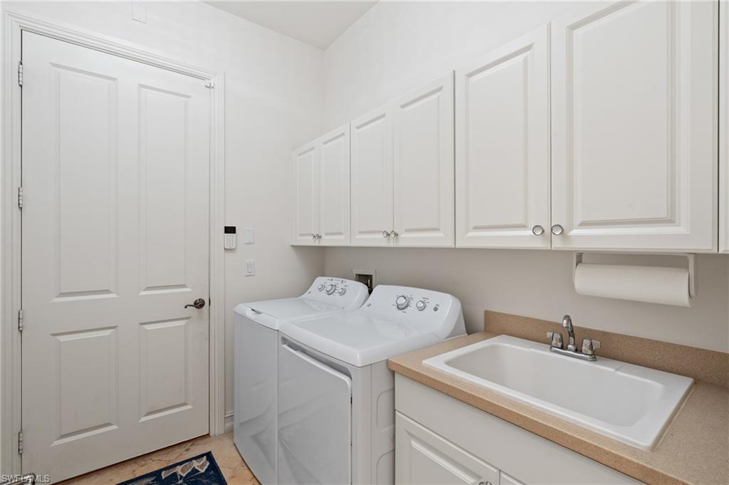 7806 Ashton Road Naples, FL 34113 - Photo 20 of 27 Washroom featuring cabinet space, a sink, and independent washer and dryer