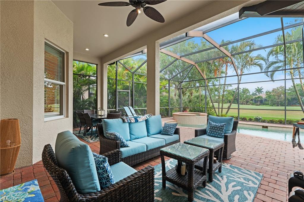 7806 Ashton Road Naples, FL 34113 - Photo 22 of 27 View of patio featuring an outdoor pool, an outdoor hangout area, glass enclosure, and ceiling fan
