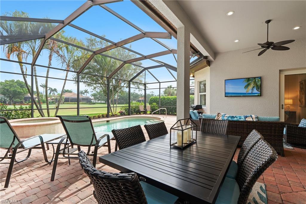 7806 Ashton Road Naples, FL 34113 - Photo 23 of 27 View of patio with an outdoor pool, outdoor dining space, a ceiling fan, an outdoor living space, and a jacuzzi