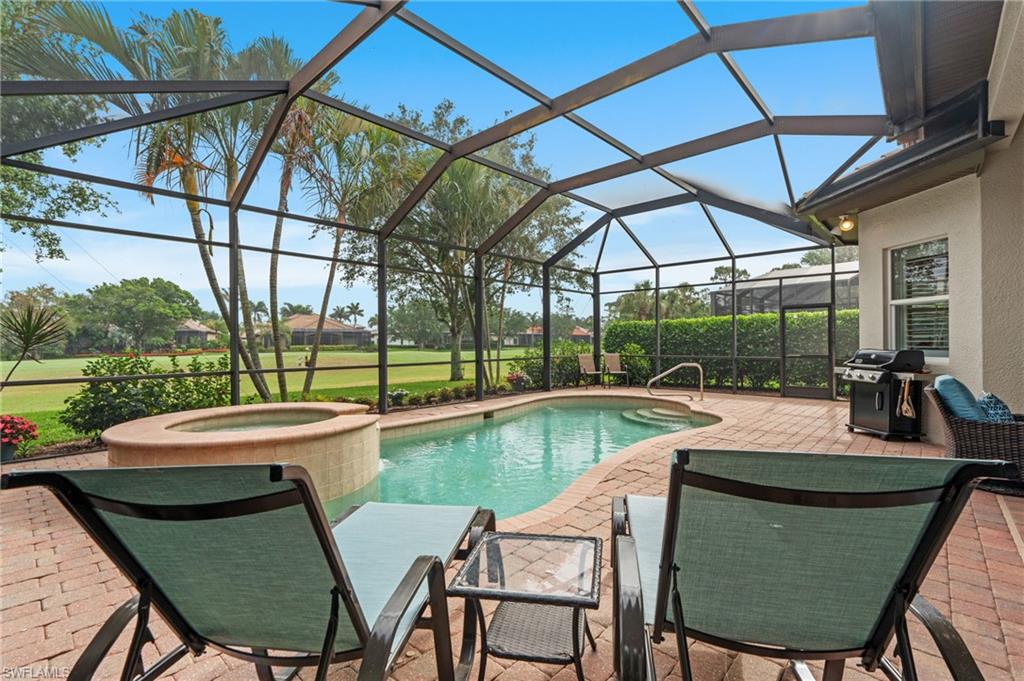 7806 Ashton Road Naples, FL 34113 - Photo 24 of 27 Pool featuring glass enclosure, a grill, a patio area, and an in ground hot tub