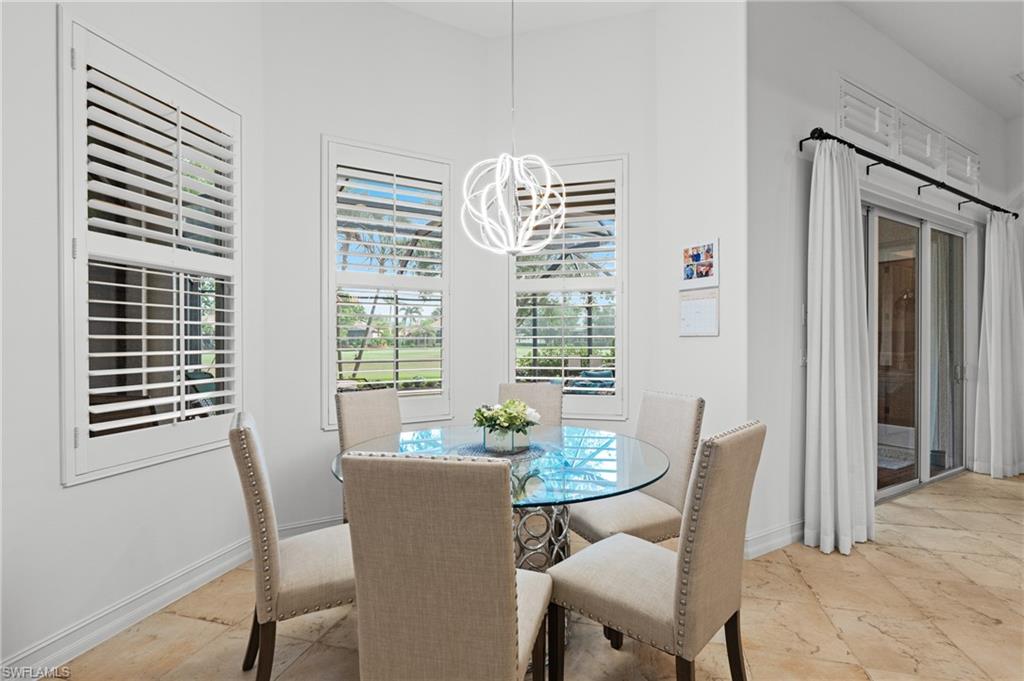 7806 Ashton Road Naples, FL 34113 - Photo 8 of 27 Dining room with baseboards, an inviting chandelier, and stone tile floors