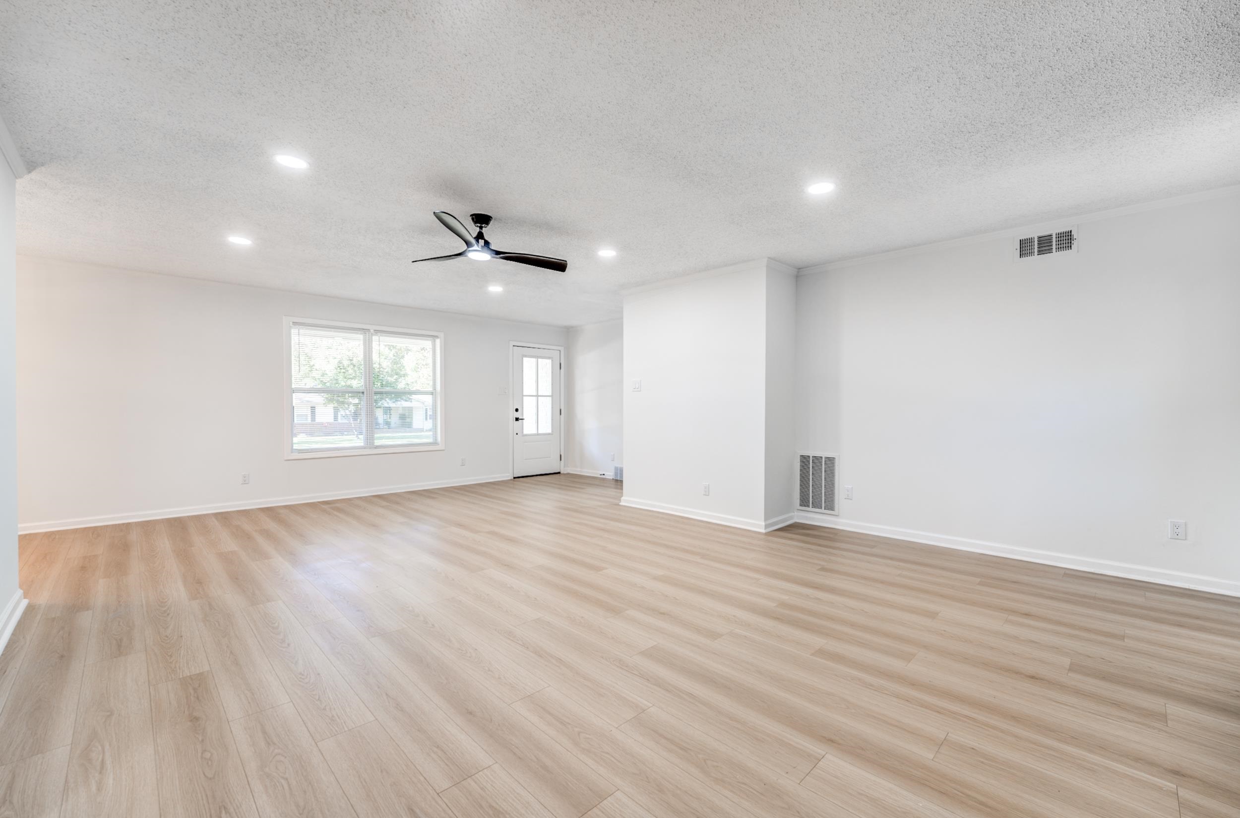 3060 Ruskin Road Bartlett, TN 38134 - Photo 5 of 30 Unfurnished living room featuring a textured ceiling, light wood-style floors, recessed lighting, and a ceiling fan