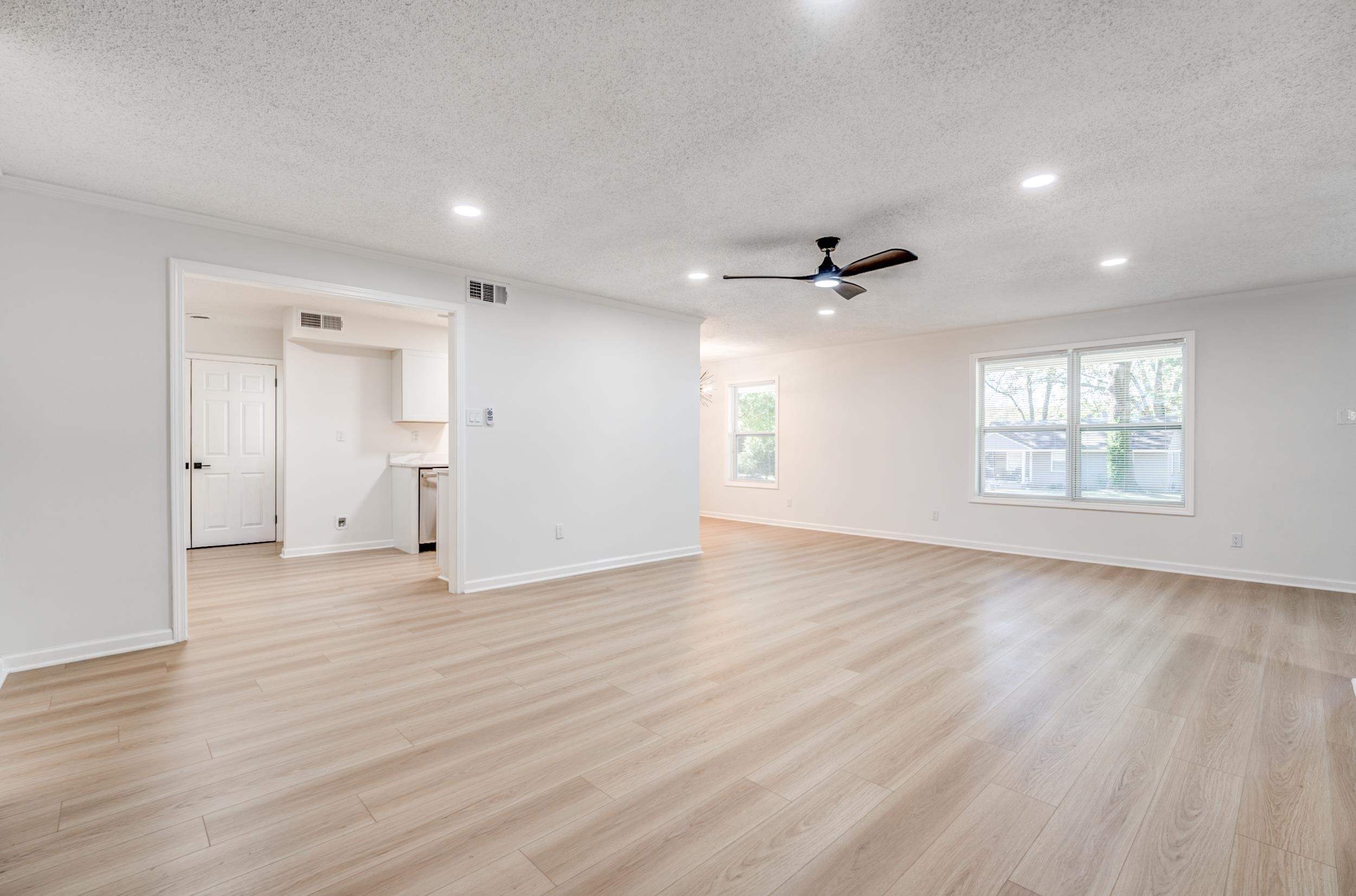 3060 Ruskin Road Bartlett, TN 38134 - Photo 6 of 30 Unfurnished living room featuring a textured ceiling, recessed lighting, light wood finished floors, and a ceiling fan