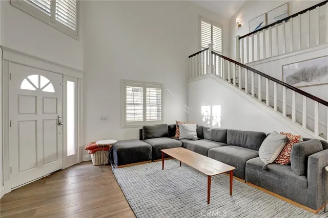 a living room with furniture and stairs