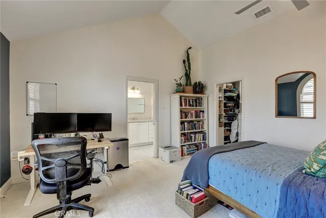 a bedroom with a workspace