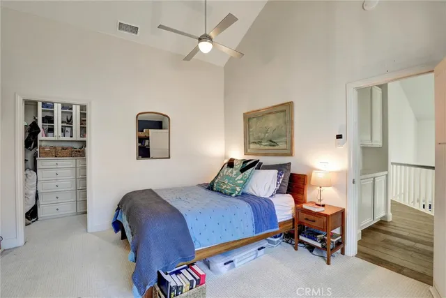 a bedroom with a bed and cabinets