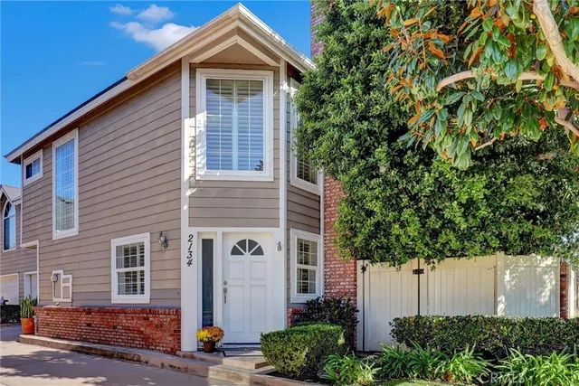 front view of a house with a tree