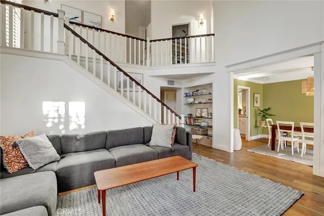 a living room with furniture wooden floor and a table