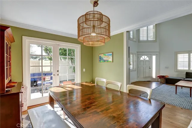 a view of a dining room with furniture a chandelier and wooden floor