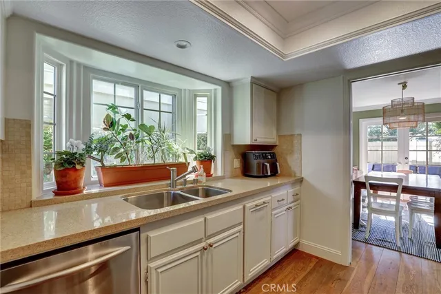 a kitchen with sink and view of living room